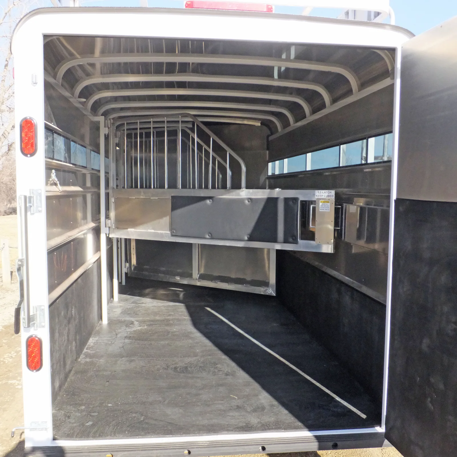 Maverick 4 horse gooseneck with standard padded jail bar dividers.